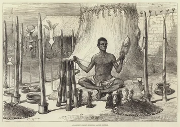 A Dahomey Priest spinning Sacred Cotton